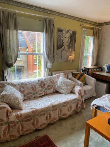 a living room with a couch and a window at Bellhay Orchard in Glastonbury