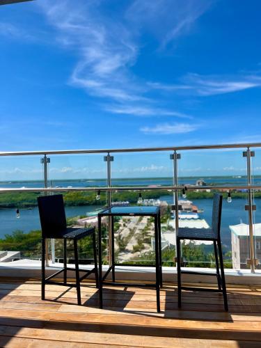 two chairs and a table on a balcony with a view at The Watermark Hotel in San Pedro
