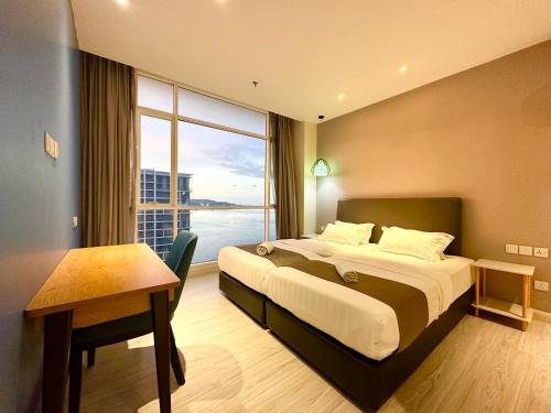 a hotel room with a bed and a large window at M Centro City Centre @ Gaya Street by Sunset Seaview Vacation Condos in Kota Kinabalu