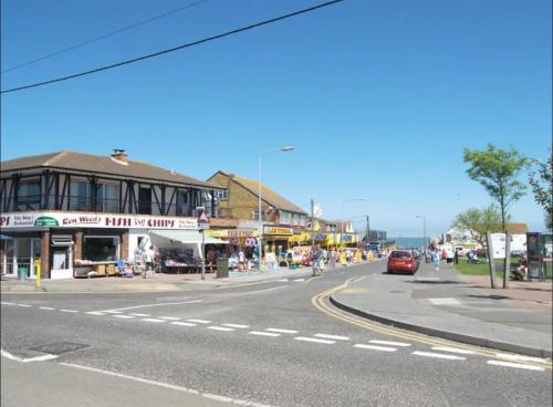 an empty street in a town with a building at 2 Bedroom Caravan With Sea Views in Eastchurch