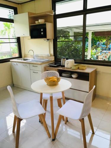 a small kitchen with a table and two chairs at Master Bedroom with private bathroom and kitchen in Phuket