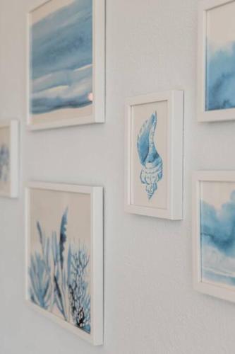 a group of pictures hanging on a wall at ☆BLUE NEST- Beachfront apartment by CASA PARAISO☆ in Cancún