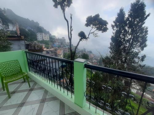 a balcony with a view of a city at Bubble Beds in Darjeeling