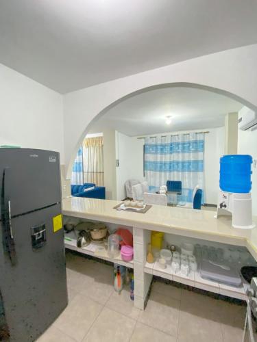 a kitchen with a counter and a refrigerator at Apartment in San Cristóbal with 2 Bedrooms, 6 Beds, Living Room, Dining Room, Kitchen, Private Balcony, Terrace with Ocean View, Washer, Satellite Internet, Near Bars and Restaurants - Blue Horizon - Galápagos Home in Puerto Baquerizo Moreno