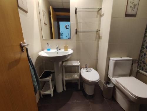 a small bathroom with a sink and a toilet at Isaola Oliva - Comfortable Apartment with Airco in Oliva