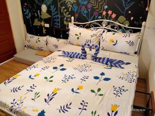 Cama con sábanas y almohadas azules y blancas en Siargao Vibes Private Resort en Bago