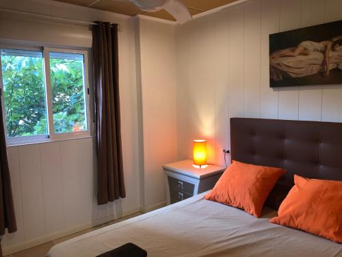 a bedroom with a bed with a lamp and a window at Caballito de Mar in Roses