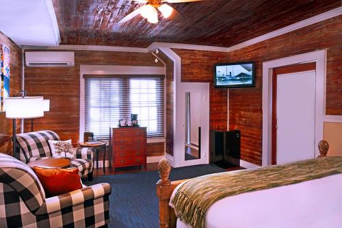 a hotel room with a bed and a television at The Inn on Fleming in Key West