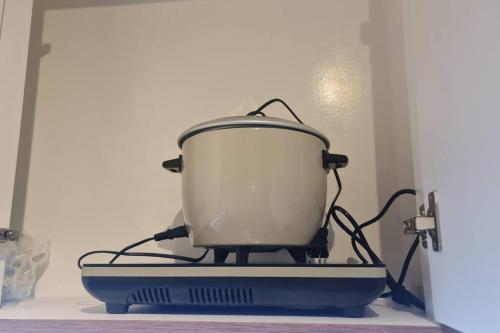 a pot sitting on top of a stove at Affordable Condo in Makati w/ Wi-Fi, Netflix, Pool in Manila