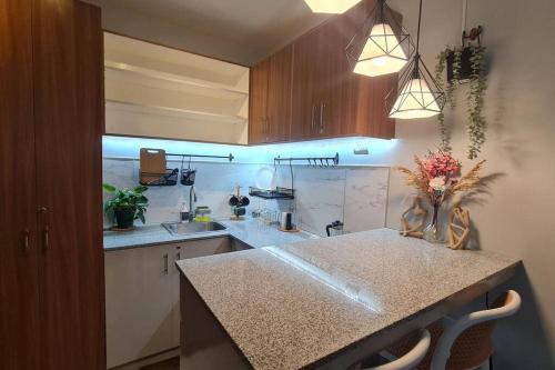 a kitchen with a counter with a sink and a counter top at Affordable Condo in Makati w/ Wi-Fi, Netflix, Pool in Manila