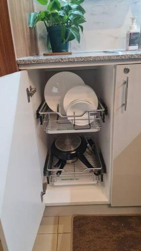 a dishwasher in a kitchen with a plant in it at Affordable Condo in Makati w/ Wi-Fi, Netflix, Pool in Manila