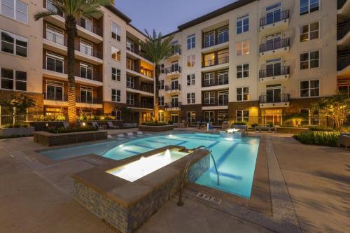 a swimming pool in front of a building at Coolest Luxury Palace Downtown in Houston