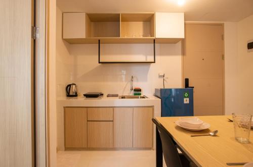 a small kitchen with a table and a counter top at Tokyo Riverside Apartment @ PIK 2 in Tangerang