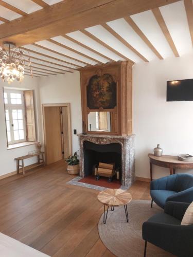 a living room with a fireplace and a couch at La Ferme de Sotrez 
