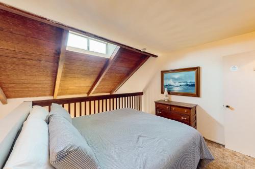 a bedroom with a large window and a bed with pillows at Sugar Shack in Carpinteria