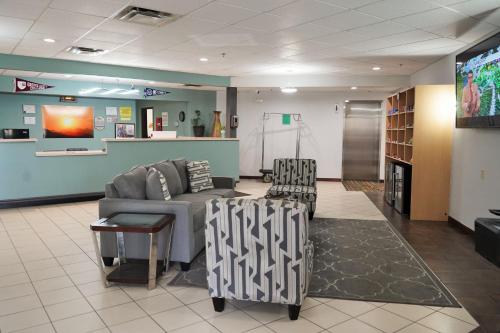 a waiting room with a couch and two chairs at Super 8 by Wyndham Grove City in Grove City