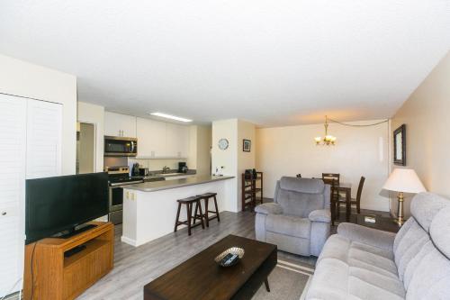 a living room with a couch and a tv at Discovery Bay 2308 condo in Honolulu