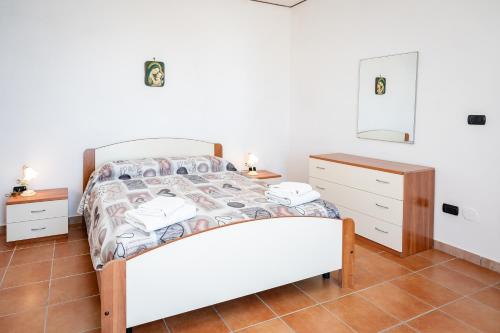 a bedroom with a bed and two night stands at casa aniello in Caprioli