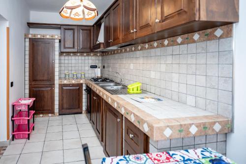 a kitchen with wooden cabinets and a counter top at casa aniello in Caprioli