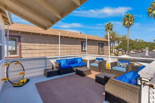 a patio with blue furniture and a tennis racket at Balboa Duplex in Newport Beach
