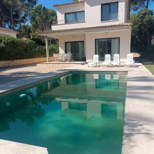a house with a swimming pool in front of a house at zen villa by villasmediterranean in El Toro