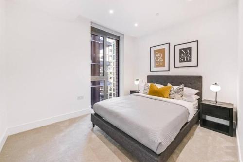 a white bedroom with a bed and a window at *Rare Find* Luxury London Collection in London