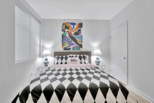 a white bedroom with a black and white bed at 10 Cozy apartment heart of Santa Monica in Los Angeles