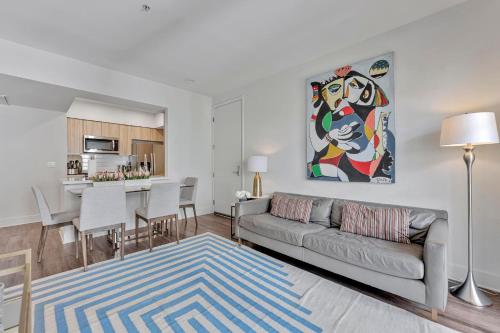 a living room with a couch and a kitchen at 7 Large Down Town Santa Monica Apartment in Los Angeles