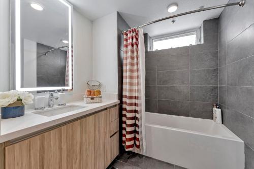 a bathroom with a tub and a sink and a shower at 7 Large Down Town Santa Monica Apartment in Los Angeles