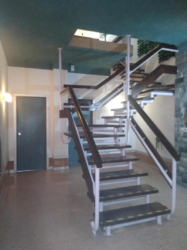 a set of stairs in a room with a door at Melaya Private Rooms in Faro