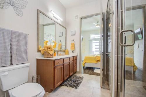 a bathroom with a toilet and a sink and a shower at Luxury Living Downtown Houston Kingbed. in Houston