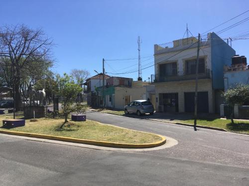a street with a car driving down a road at TERRAZAS DEL SUR in Ezpeleta