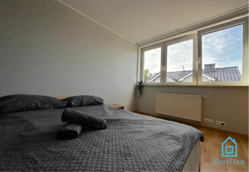 a bedroom with a bed and a large window at ZigZag Room in Gdańsk