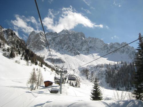 a ski lift going up a snow covered mountain at 20 VENTI in Angolo Terme