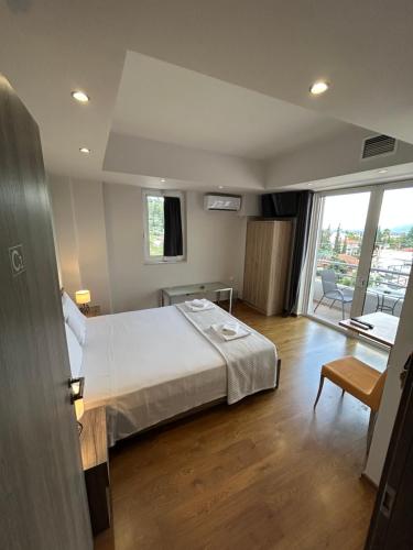 a hotel room with a bed and a balcony at Peania Domus in Paianía