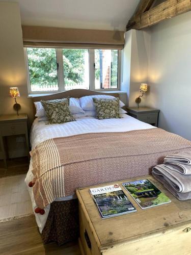 1 dormitorio con 1 cama grande y ventana en The Most Magical Woodshed, en Daventry
