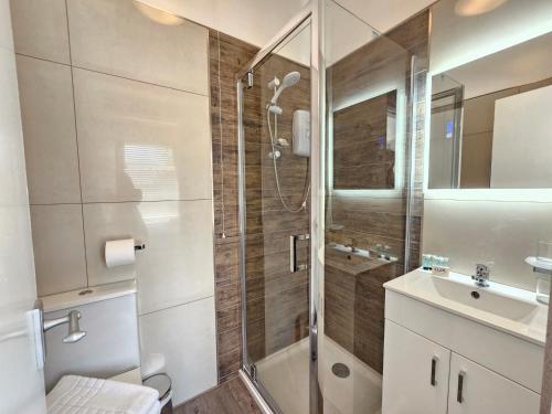 a bathroom with a shower and a sink at ABBEY HOTEL in Stafford