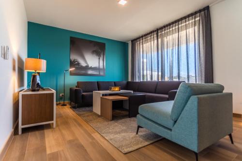a living room with a couch and a chair at Tuscany Residence Aruba in Palm-Eagle Beach