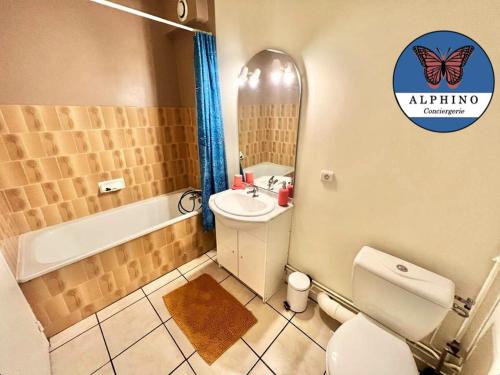 a bathroom with a toilet and a sink and a mirror at Le Clémenceau fonctionnel et tout équipé in Limoges