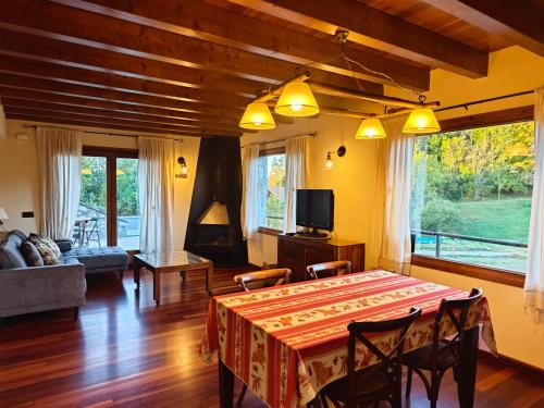 a living room with a table and a couch at Els Tres Sols in Camprodon