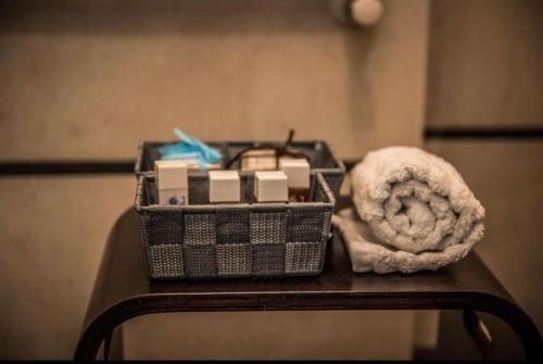 a basket of items on a table with a towel at Piazza Italia Luxury Apartment in Chianciano Terme