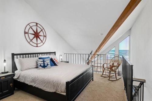 a bedroom with a bed and a balcony at Beachfront Bliss at Rockaway Creek Inn in Rockaway Beach