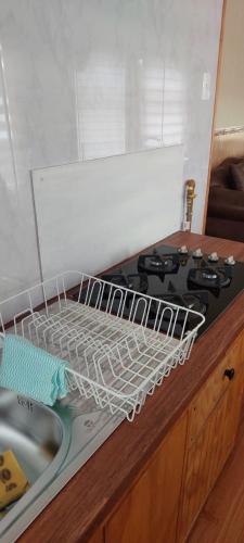 a drying rack in a kitchen next to a stove at TyP Departamentos in Puerto Natales