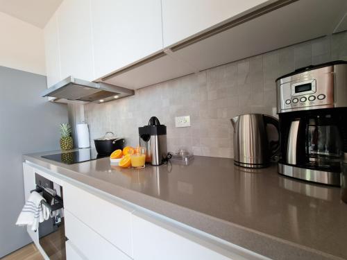 a kitchen with a counter with oranges on it at Tuscany Residence Aruba in Palm-Eagle Beach