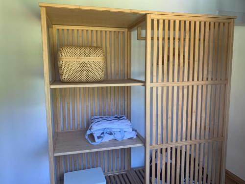 a wooden book shelf with a bag in it at A chousa da folgueira in Ordes