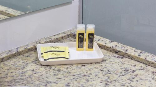 two toothbrushes on a plate on a counter at Nobile Suítes Tambaú in João Pessoa