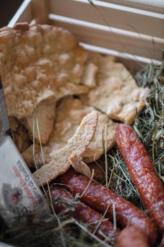 a box of food with sausage and other foods at Living Miramor in Racines