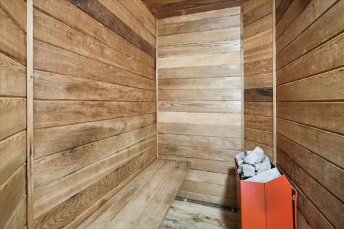 a sauna with wooden walls and a red box at 4-Bedroom Townhouse with Sauna Snow Flake in Killington