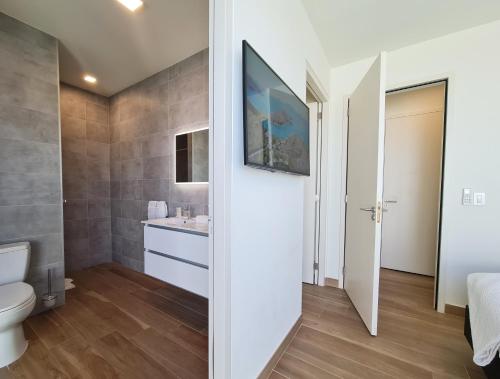 a bathroom with a toilet and a sink at Tuscany Residence Aruba in Palm-Eagle Beach