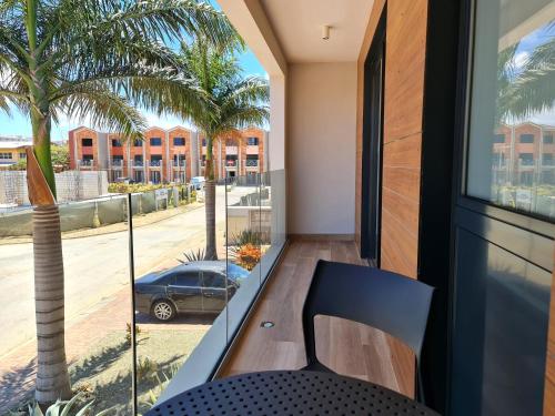 a balcony with a chair and a view of a street at Tuscany Residence Aruba in Palm-Eagle Beach